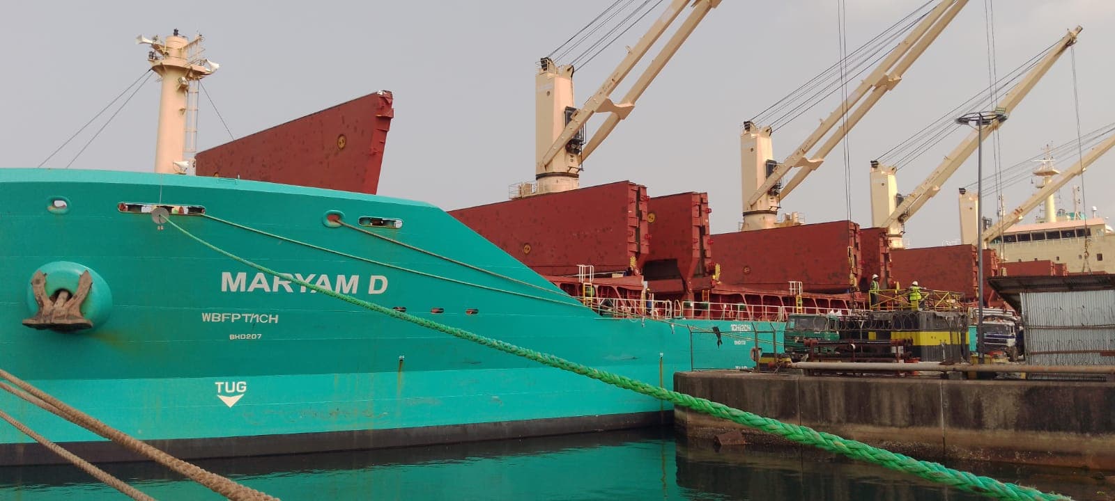 Bulk carrier MARYAM D docked at a Liberian port under loading cranes